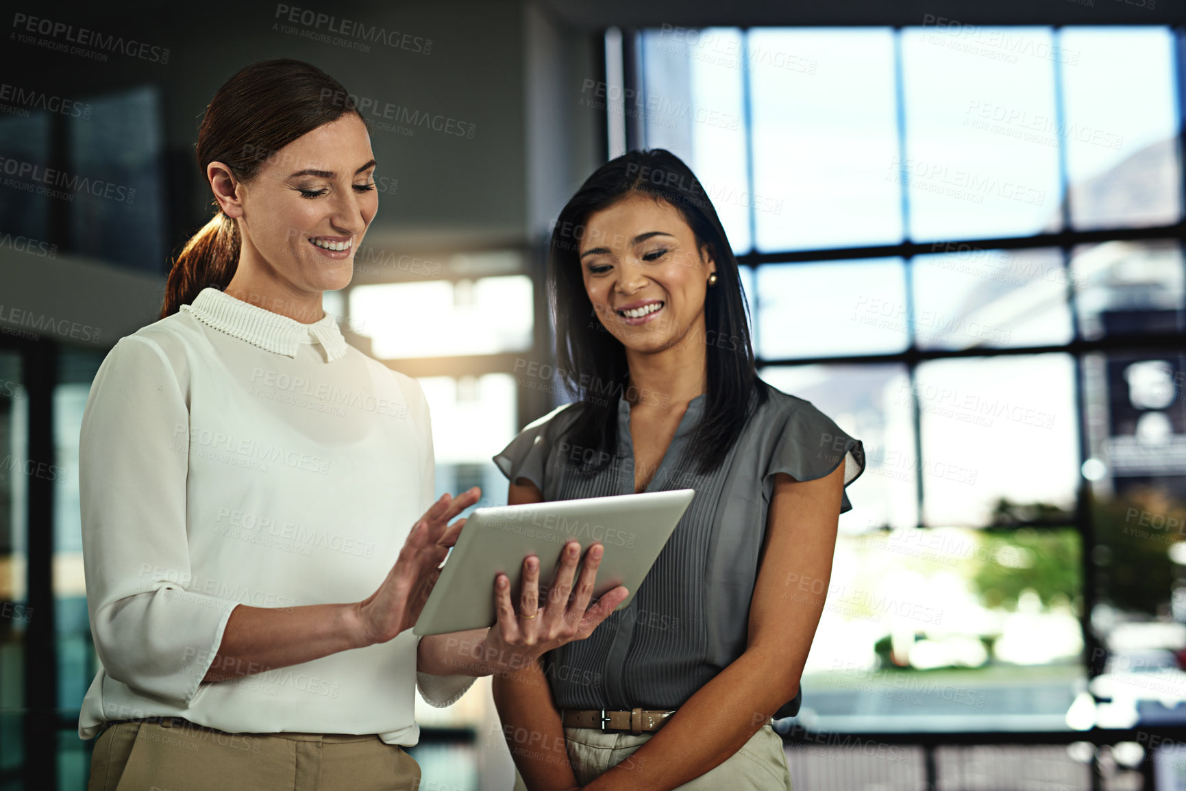 Buy stock photo Businesswoman, partner and smile with tablet in office of teamwork planning, online schedule or reading email with ideas. People, secretary and discussion for meeting, brainstorming or review report 