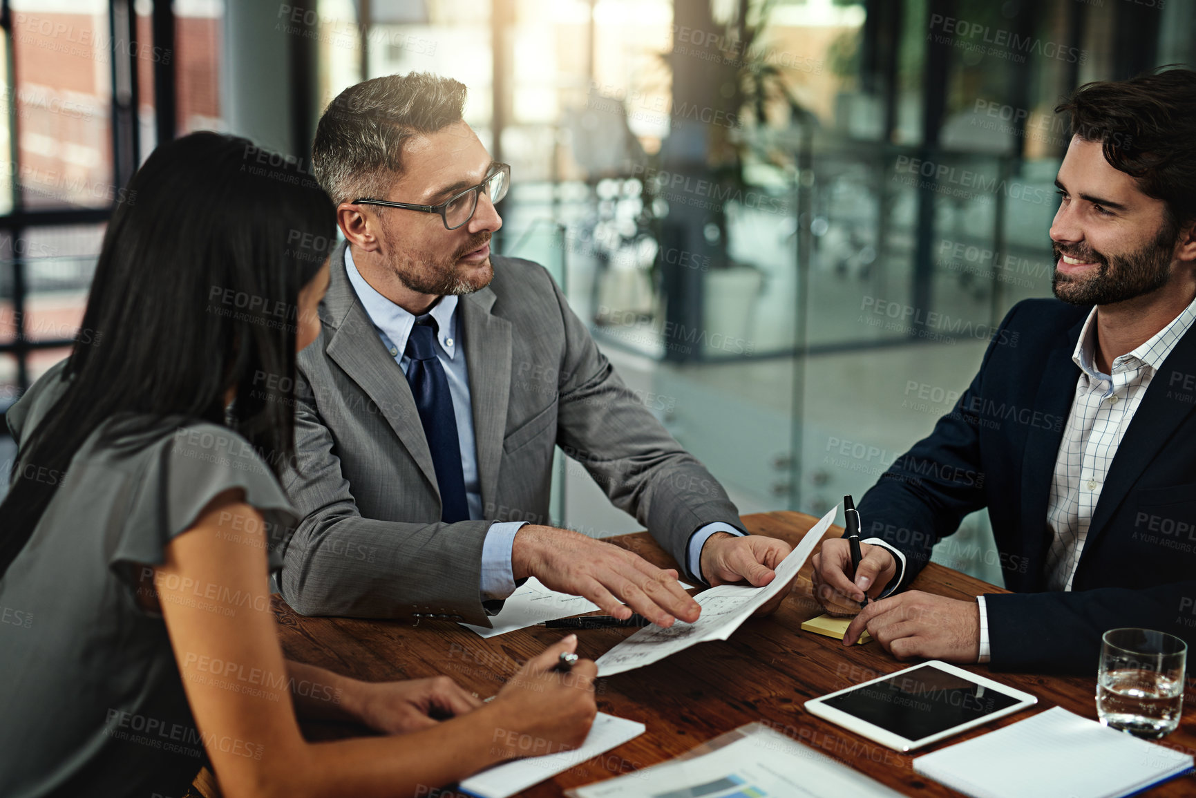 Buy stock photo Shot of a group of businesspeople meeting in the boardroom