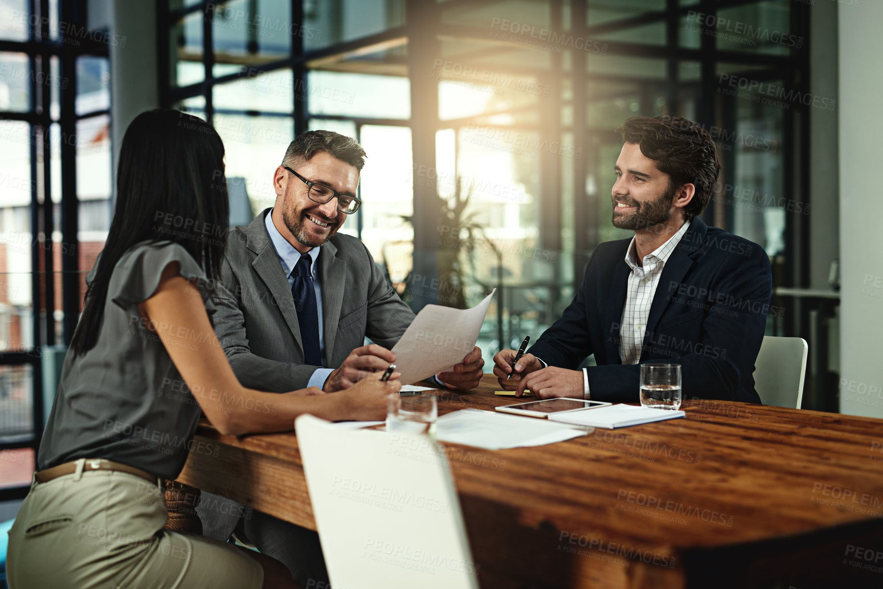 Buy stock photo Shot of a group of businesspeople meeting in the boardroom