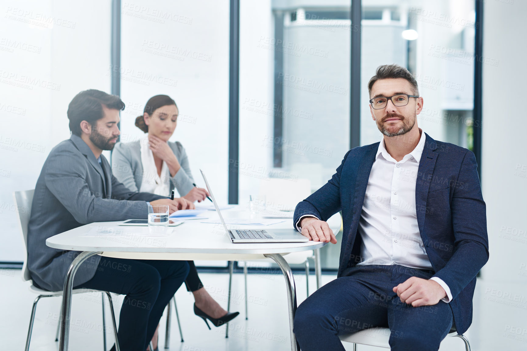 Buy stock photo Portrait of a handsome businessman sitting in the boardroom during a meeting