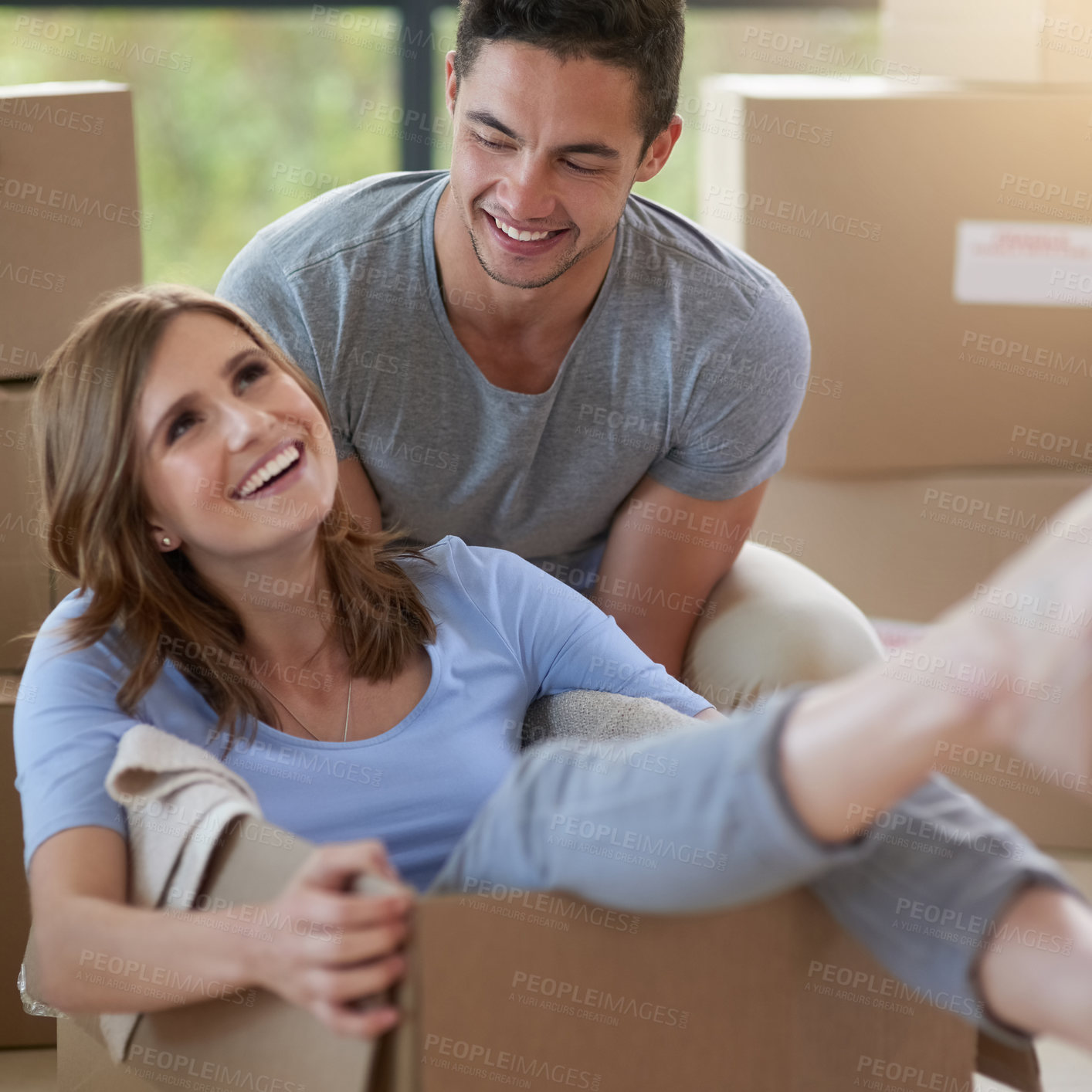 Buy stock photo Happy, couple and moving with boxes in new home for property, playing or together for growth. Man, house and woman in cardboard with smile for investment in future, real estate with mortgage in USA