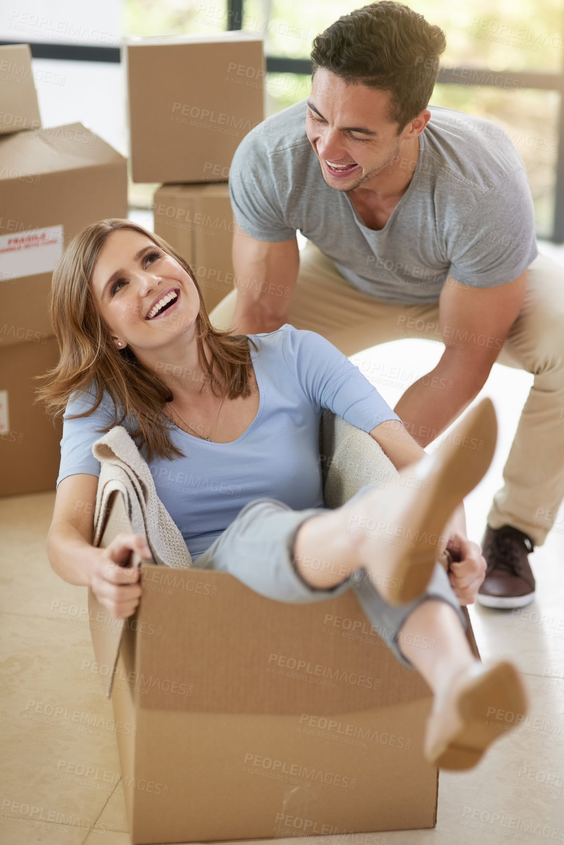 Buy stock photo Happy, couple and moving with cardboard in new home for real estate, playing or together for growth. Man, house and woman in box with smile for investment in future, property with mortgage in USA