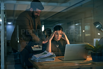 Buy stock photo Shot of a young woman looking stressed while her colleague tries to console her