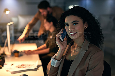 Buy stock photo Shot of a young woman talking on her phone with her colleagues in the background