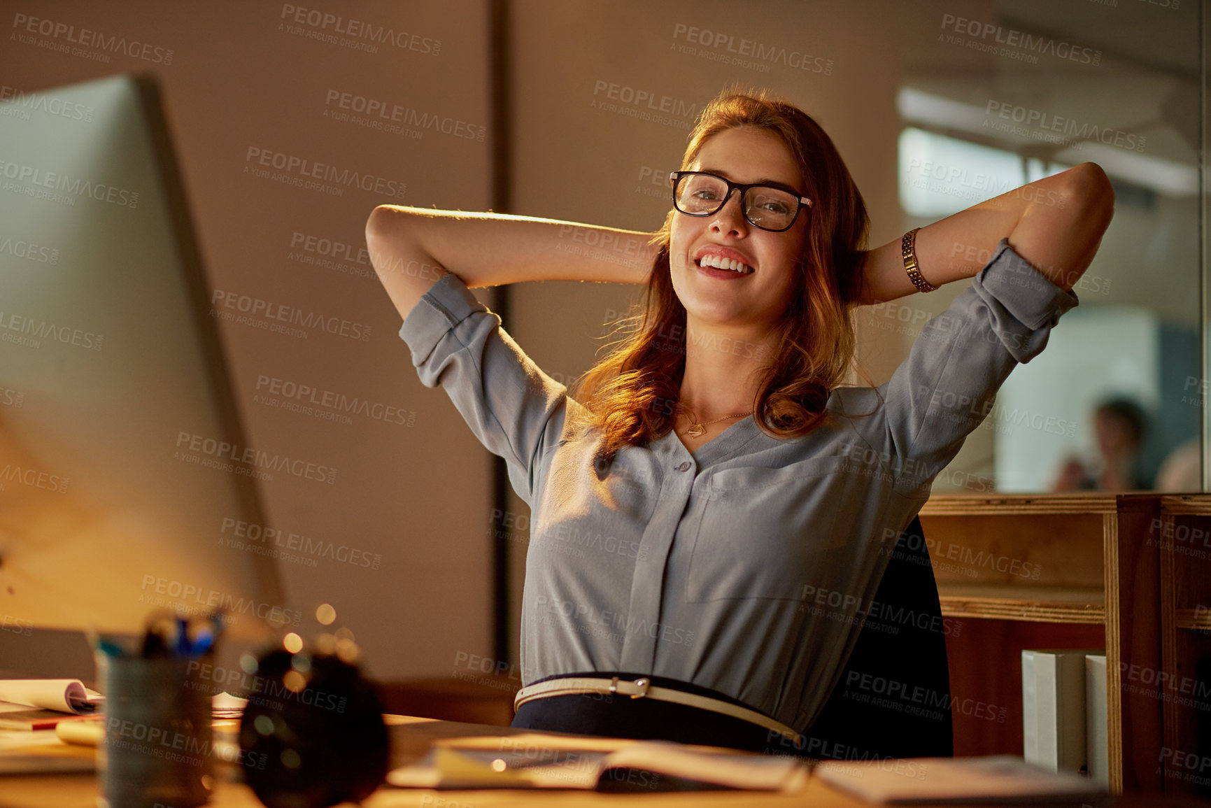 Buy stock photo Portrait of an attractive young businesswoman sitting with her hands behind her head in the office