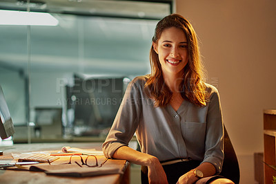 Buy stock photo Portrait of an attractive young businesswoman working late in the office