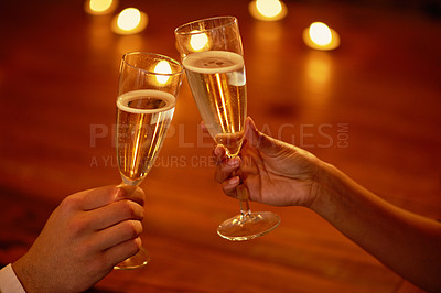 Buy stock photo Shot of an unidentifiable couple toasting with champagne