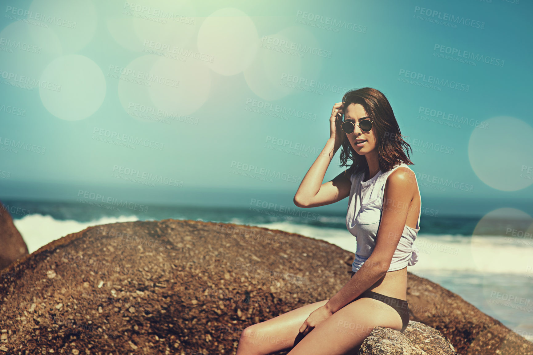 Buy stock photo Shot of an attractive young woman enjoying a day on the beach