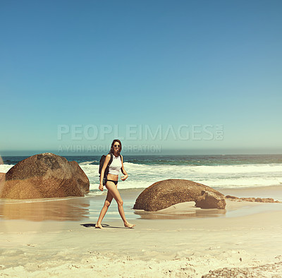 Buy stock photo Shot of a backpacker enjoying a day at the beach