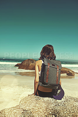 Buy stock photo Shot of a young backpacker admiring the beautiful scenery at the beach
