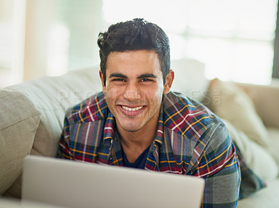Buy stock photo Man, portrait and laptop on sofa for relax entertainment or internet search, streaming or subscription. Male person, face and couch for weekend in apartment for watching in house, media or networking