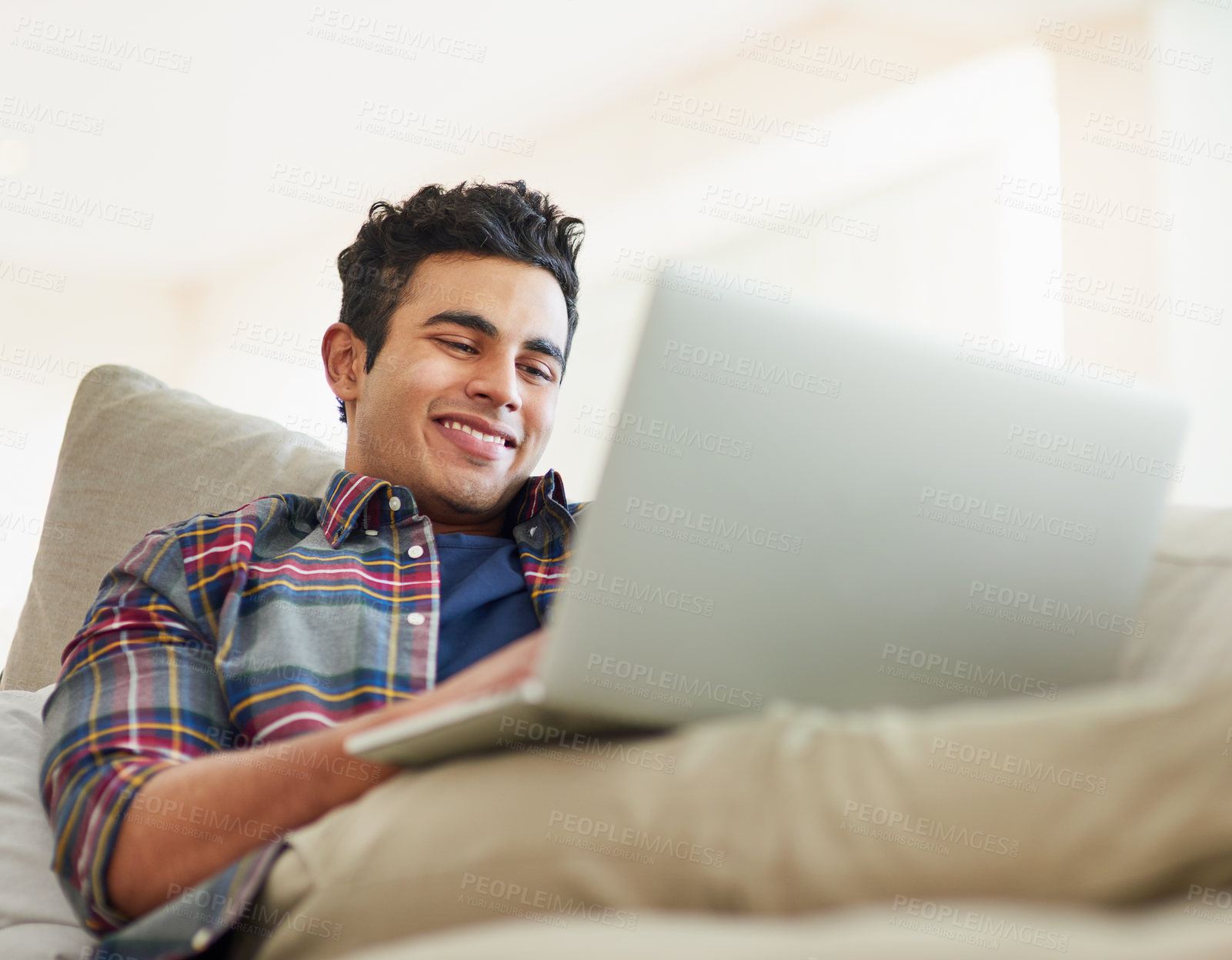 Buy stock photo Man, laptop and sofa for relax connection with streaming service for free time, stress relief or resting. Male person, smile and couch with technology for online subscription, watching or internet