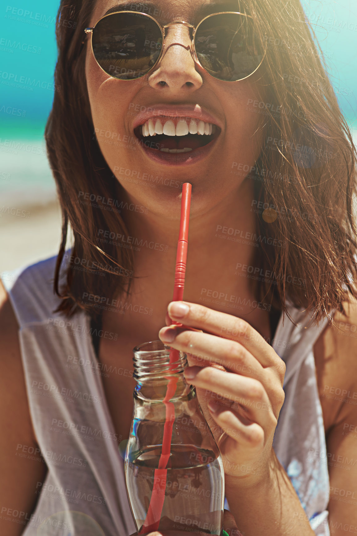 Buy stock photo Portrait of a sexy young woman enjoying a drink at the beach