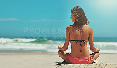 Buy stock photo Rearview shot of a sexy young woman sitting on the beach
