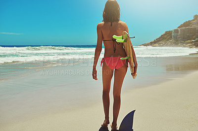 Buy stock photo Rearview shot of a young and sexy female surfer on the beach