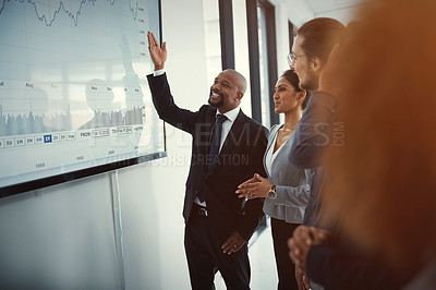 Buy stock photo Shot of a mature businessman giving a presentation in the boardroom