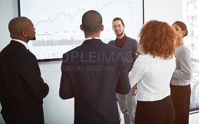 Buy stock photo Shot of a young businessman giving a presentation in the boardroom