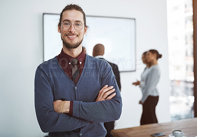 Buy stock photo Portrait of a young businessman in the office with his colleagues in the background