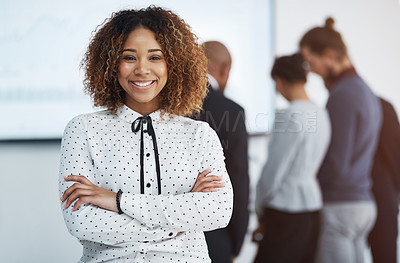 Buy stock photo Portrait of a young businesswoman in the office with her colleagues in the background