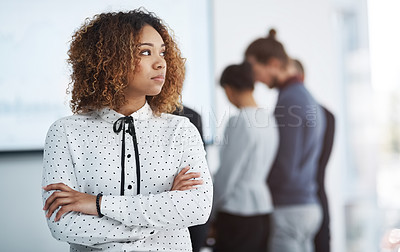 Buy stock photo Shot of a young businesswoman in the office with her colleagues in the background