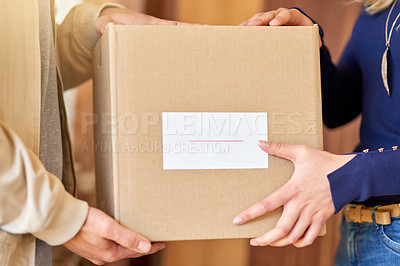 Buy stock photo Shot of an unidentifiable delivery man making a delivery to a customer at her home