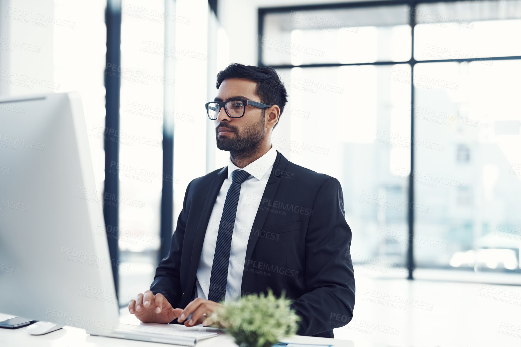 Buy stock photo Computer, report and typing with business man at desk in office for administration or research. Glasses, information and PC with corporate employee person in professional workplace for development