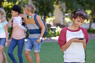 Buy stock photo Woman, headphones and smartphone on campus, typing and break with education app at college. Student, smile and cellphone by social media on internet, technology and university outdoor for connection