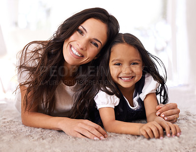 Buy stock photo Happy mother, portrait and child lying on floor in relax for bonding, love or care together at home. Face of mom, parent and little girl, daughter or kid with smile in living room for family time