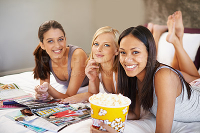 Buy stock photo Friends, popcorn and portrait for sleepover, social and bedroom for bonding and excited group for snacks. Female people, together and magazines for jokes, besties and entertainment with conversation 