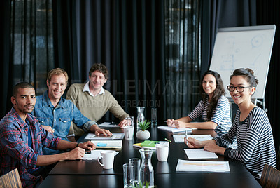 Buy stock photo Portrait of a diverse group of professionals sitting at a table in a boardroom