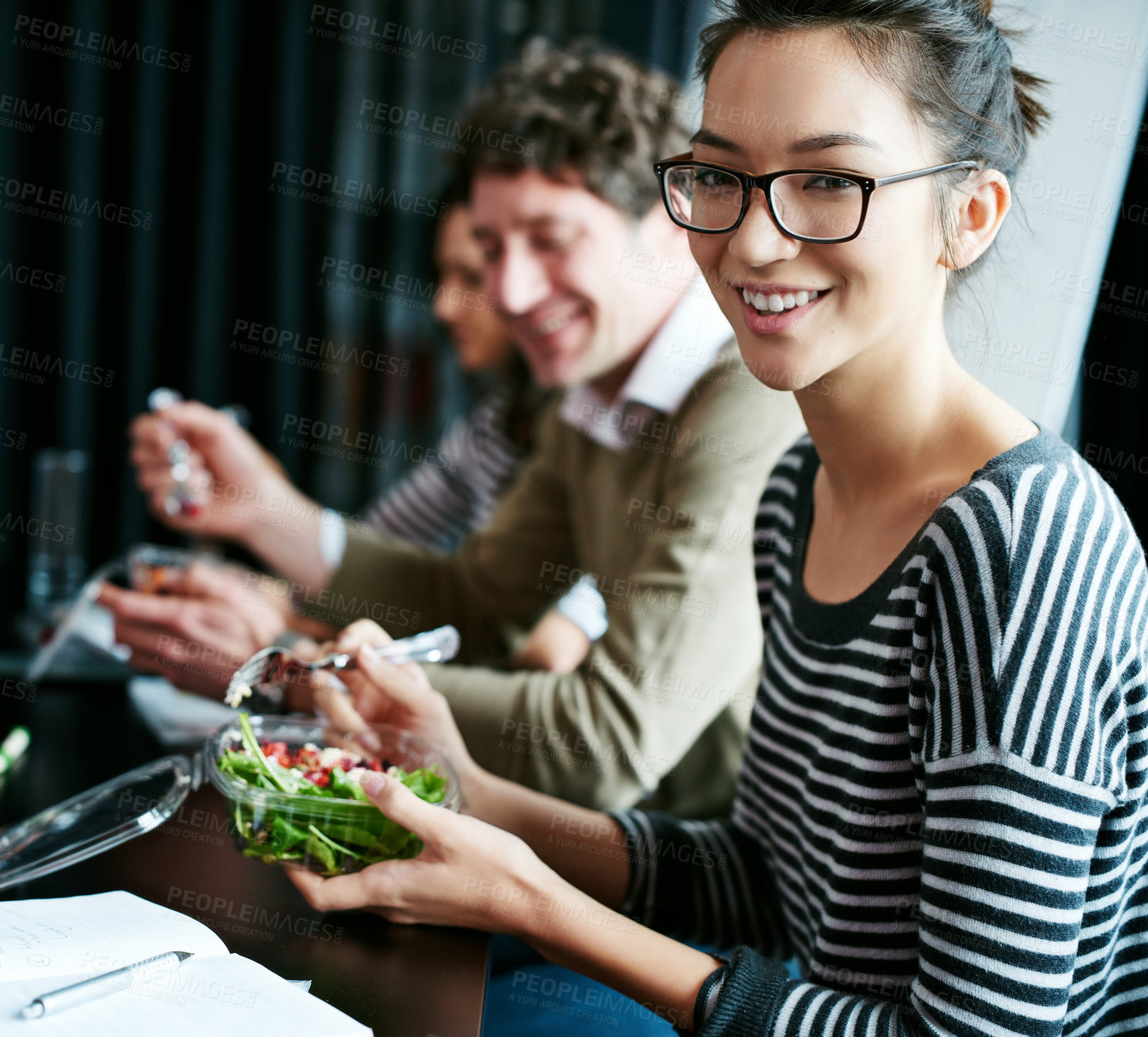 Buy stock photo Meeting, lunch and portrait of woman in office with salad for team building meal with collaboration. Group, smile and female designer with colleagues eating healthy food in workplace boardroom.
