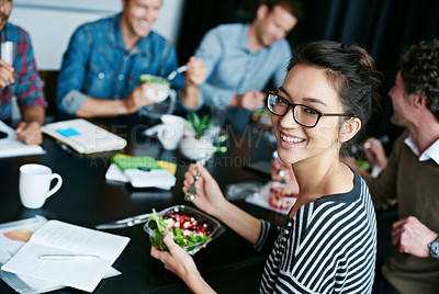 Buy stock photo Portrait of a young office worker  eating lunch with coworkers at a boardroom table