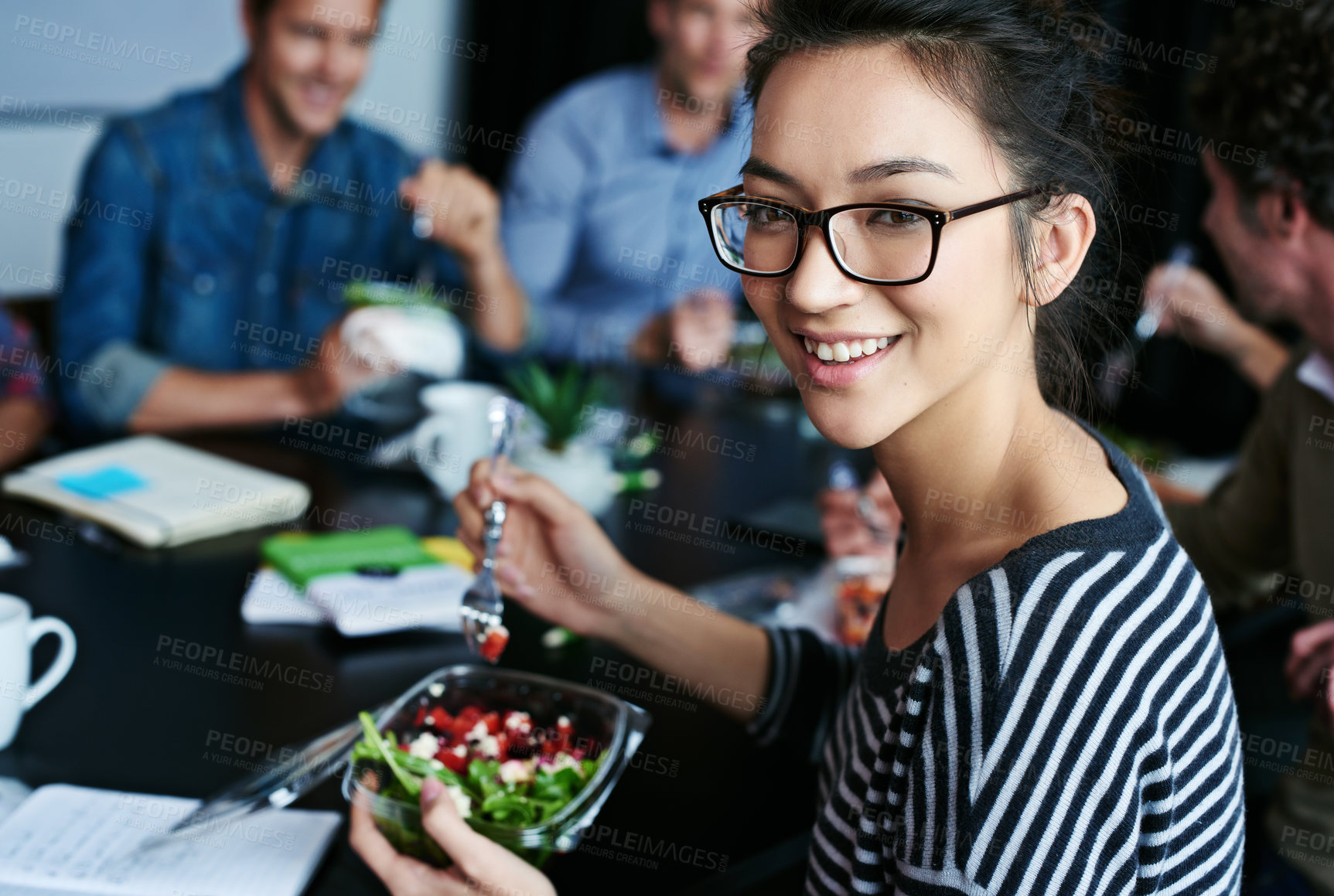 Buy stock photo Meeting, food and portrait of woman with salad in office for team building lunch for collaboration. Discussion, smile and business female designer with colleagues eating healthy meal in workplace.