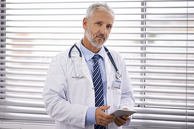 Buy stock photo Portrait of a mature male doctor holding a digital tablet