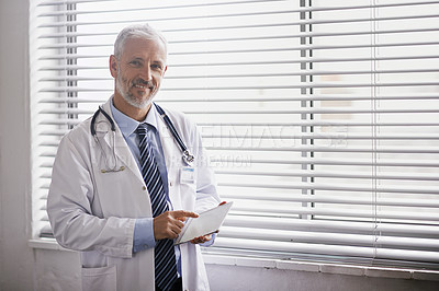 Buy stock photo Portrait of a mature male doctor using a digital tablet
