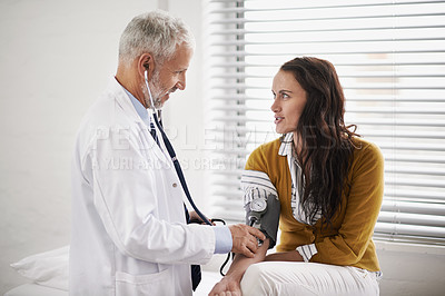 Buy stock photo Doctor, blood pressure and a woman patient at hospital for a consultation with health insurance. Man with a stethoscope to check pulse of person for medical exam, wellness and hypertension diagnosis