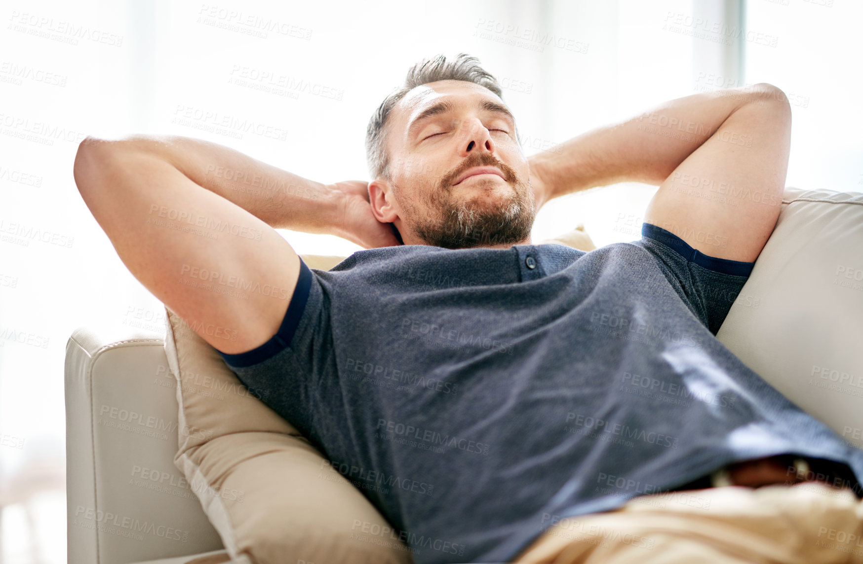 Buy stock photo Shot of a handsome mature man relaxing on the sofa at home