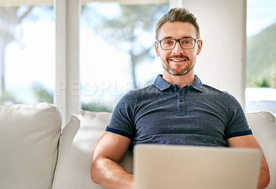 Buy stock photo Smile, laptop and portrait of man on sofa working on freelance creative project at apartment. Happy, glasses and mature male writer with computer for research online with blog in living room at home.