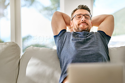 Buy stock photo Relax, laptop and man on sofa in living room working on freelance creative project at apartment. Rest, glasses and mature male writer with computer for research online with internet blog at home.