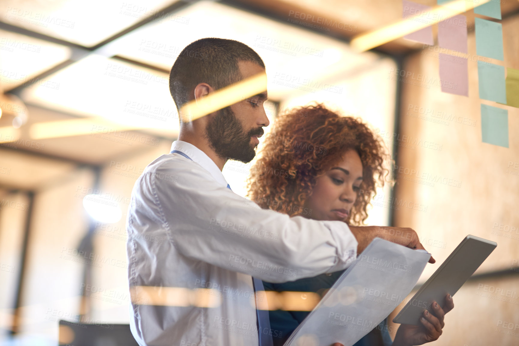 Buy stock photo Office, employees and meeting on glass wall with tablet, document and sticky notes for planning and strategy. Business, people and coworking for company vision or growth on teamwork and collaboration