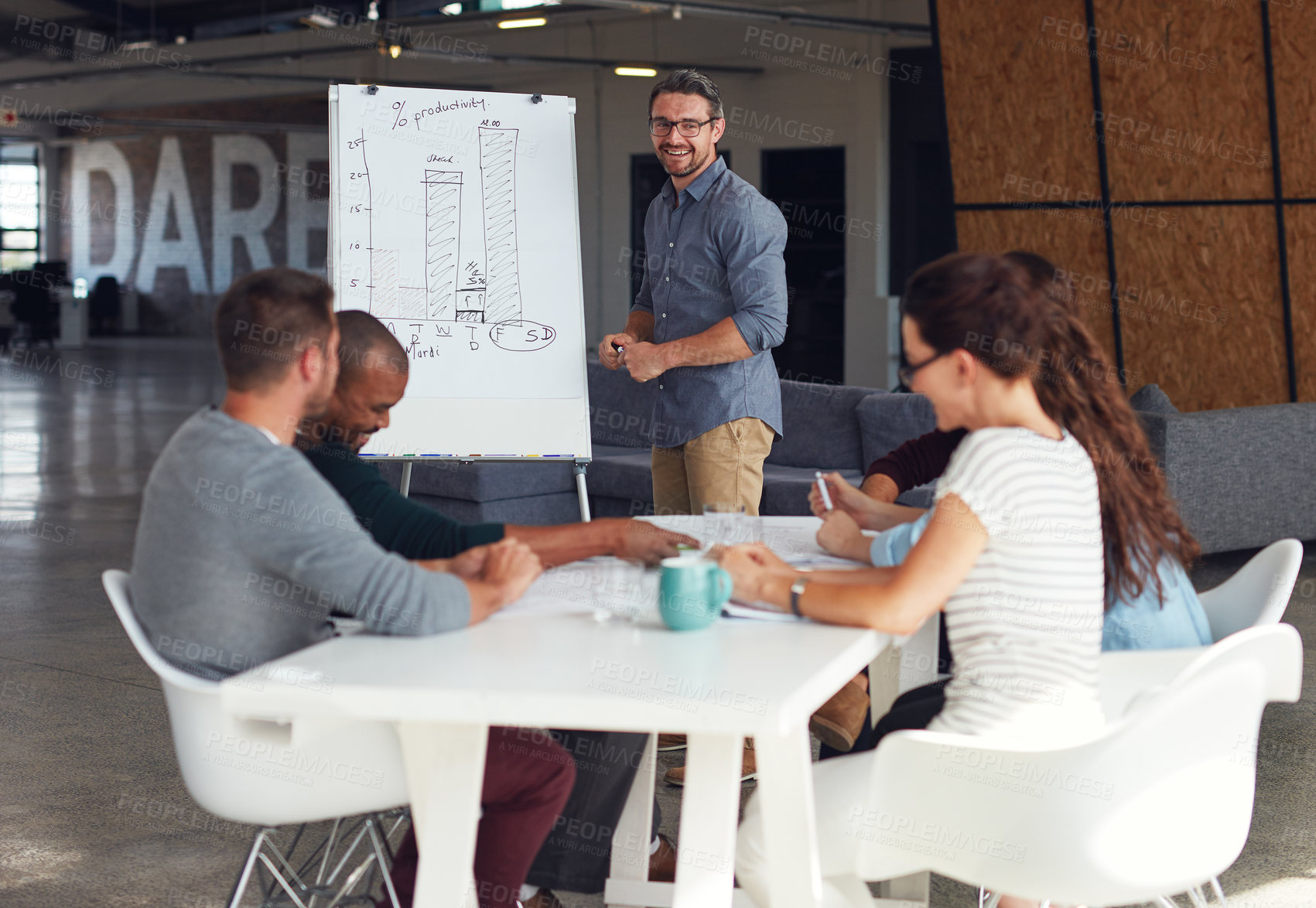 Buy stock photo Shot of a mature man giving a whiteboard presentation to colleagues in an office