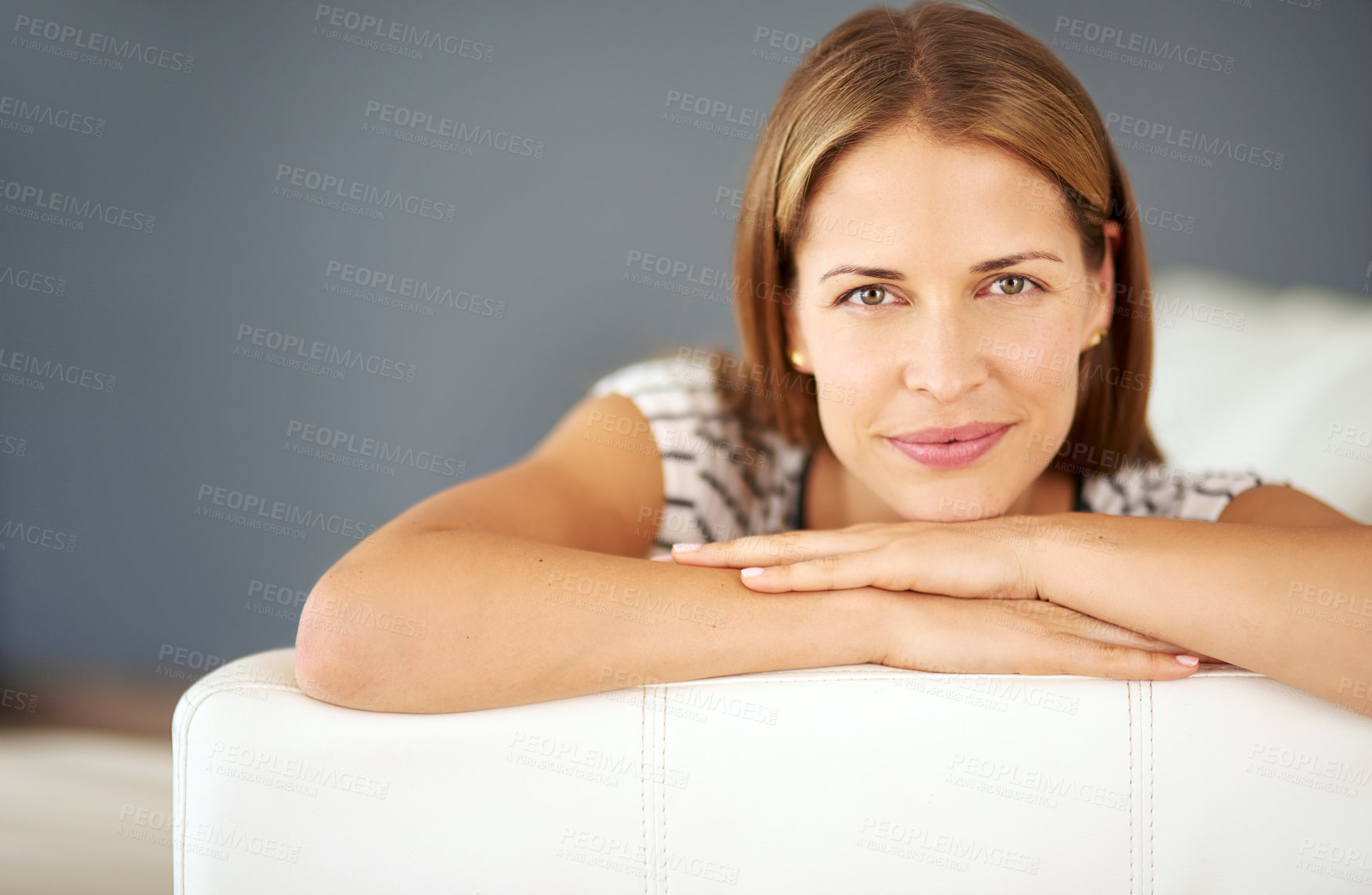 Buy stock photo Shot of a young woman relaxing on the sofa at home