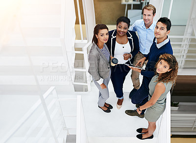 Buy stock photo Portrait of a group of coworkers having a meeting in a stairwell in a modern office
