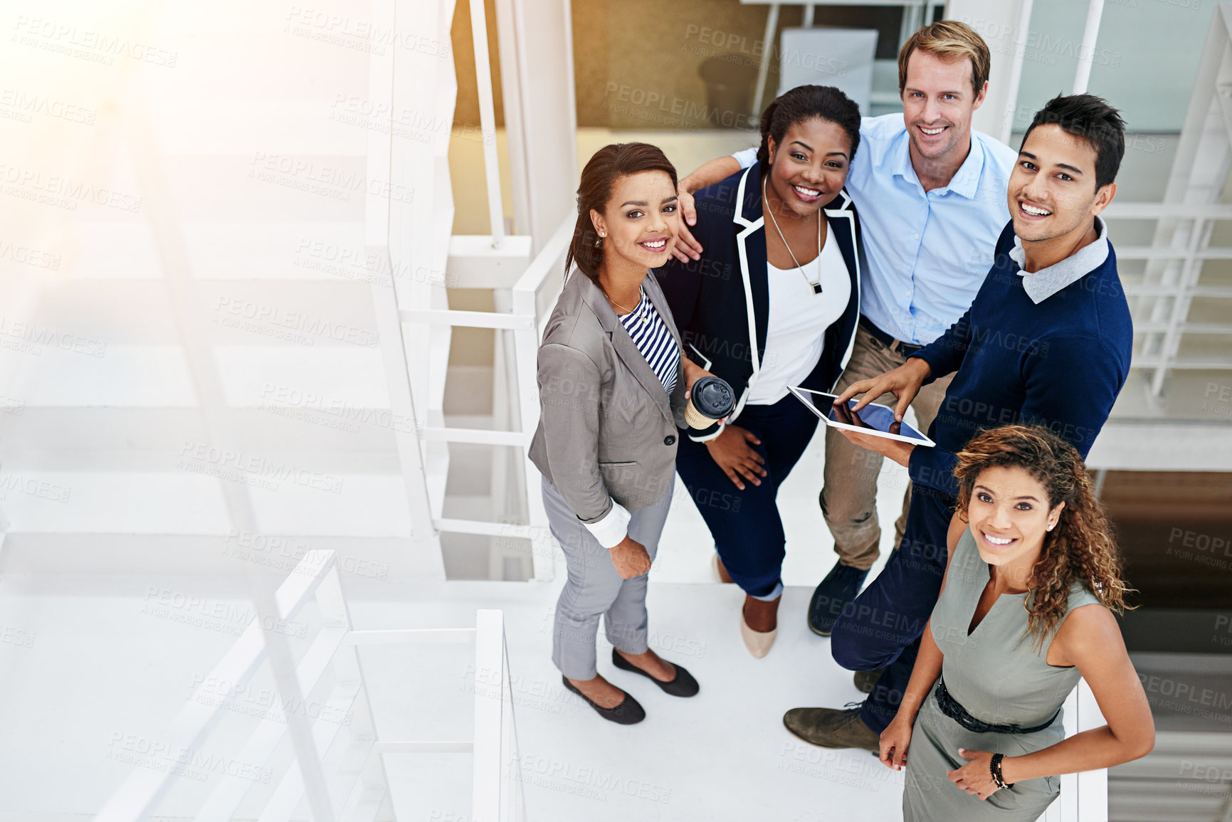 Buy stock photo Portrait of a group of coworkers having a meeting in a stairwell in a modern office