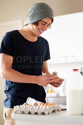 Buy stock photo Cropped shot of a young man cooking at home