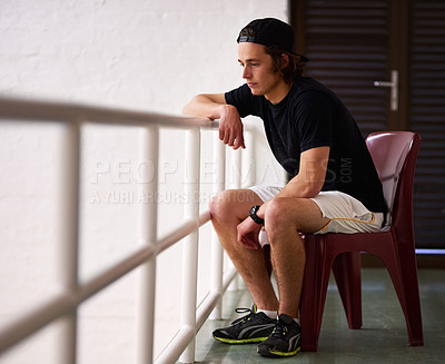 Buy stock photo Sports, watching and man on chair in court or arena for training, match and practice to support or relax. Squash, fan and person in audience looking at workout, competition tournament or indoor game