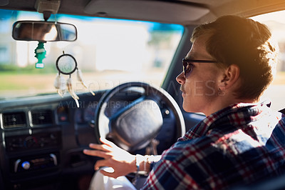 Buy stock photo Rearview shot of a young man driving a car