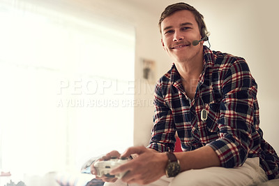 Buy stock photo Portrait of a happy young man playing video games at home