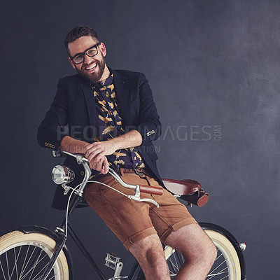 Buy stock photo Portrait of a trendy young man posing in studio with his bicycle