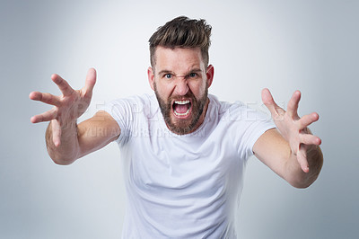 Buy stock photo Portrait of an angry young man losing his temper in studio